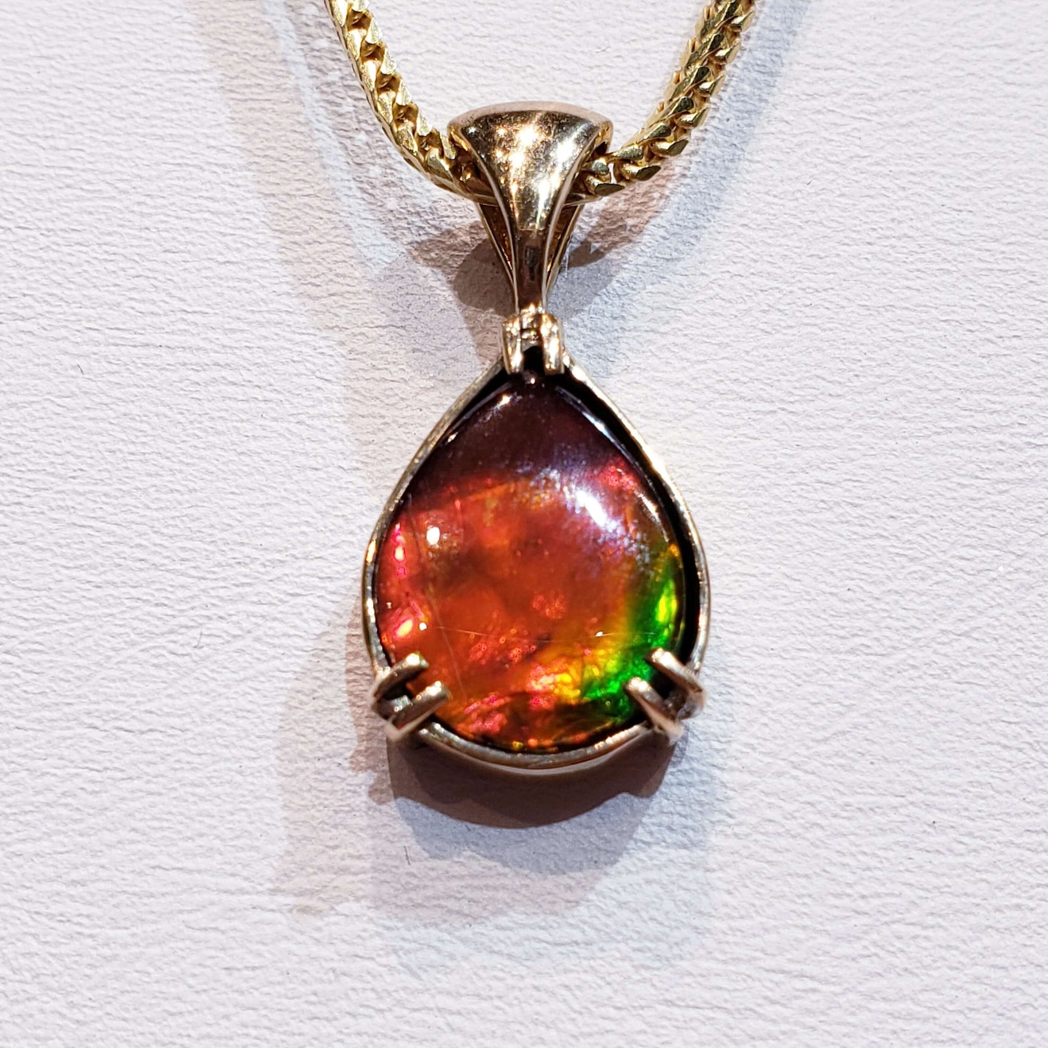 Ammolite Pear Pendant Set in 14KYG with a 10x12mm Gem PN: E21024 %product from Empire Ammolite
