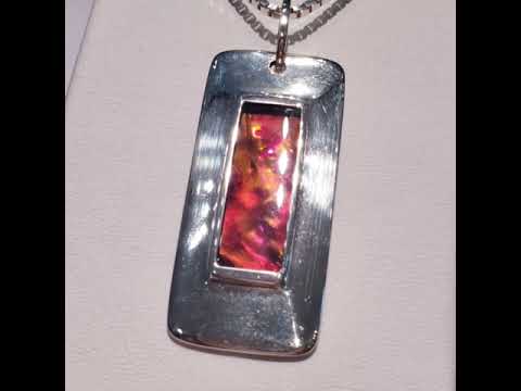 A Dog-Tag Styled Modern Pendant With A Wide Silver Boarder