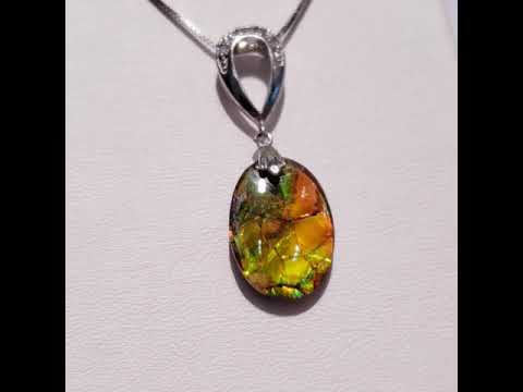 A 12x15MM Genuine Oval Ammolite Pendant Video In Sterling Silver With CZ Accent Stones.